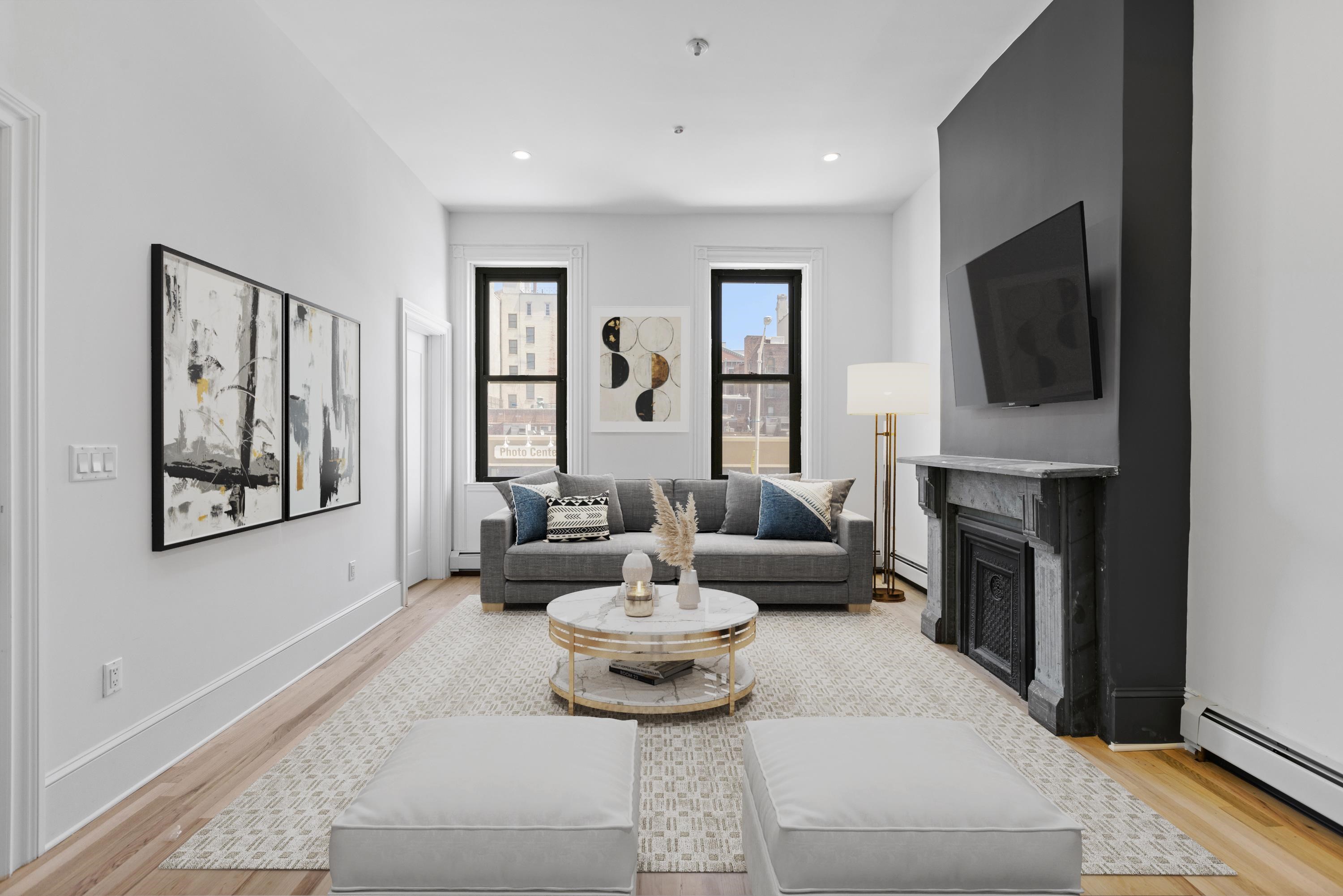 76 Washington Street, Unit 2 Hoboken, NJ 07030 - Photo 2 of 14 a living room with fireplace furniture and a flat screen tv