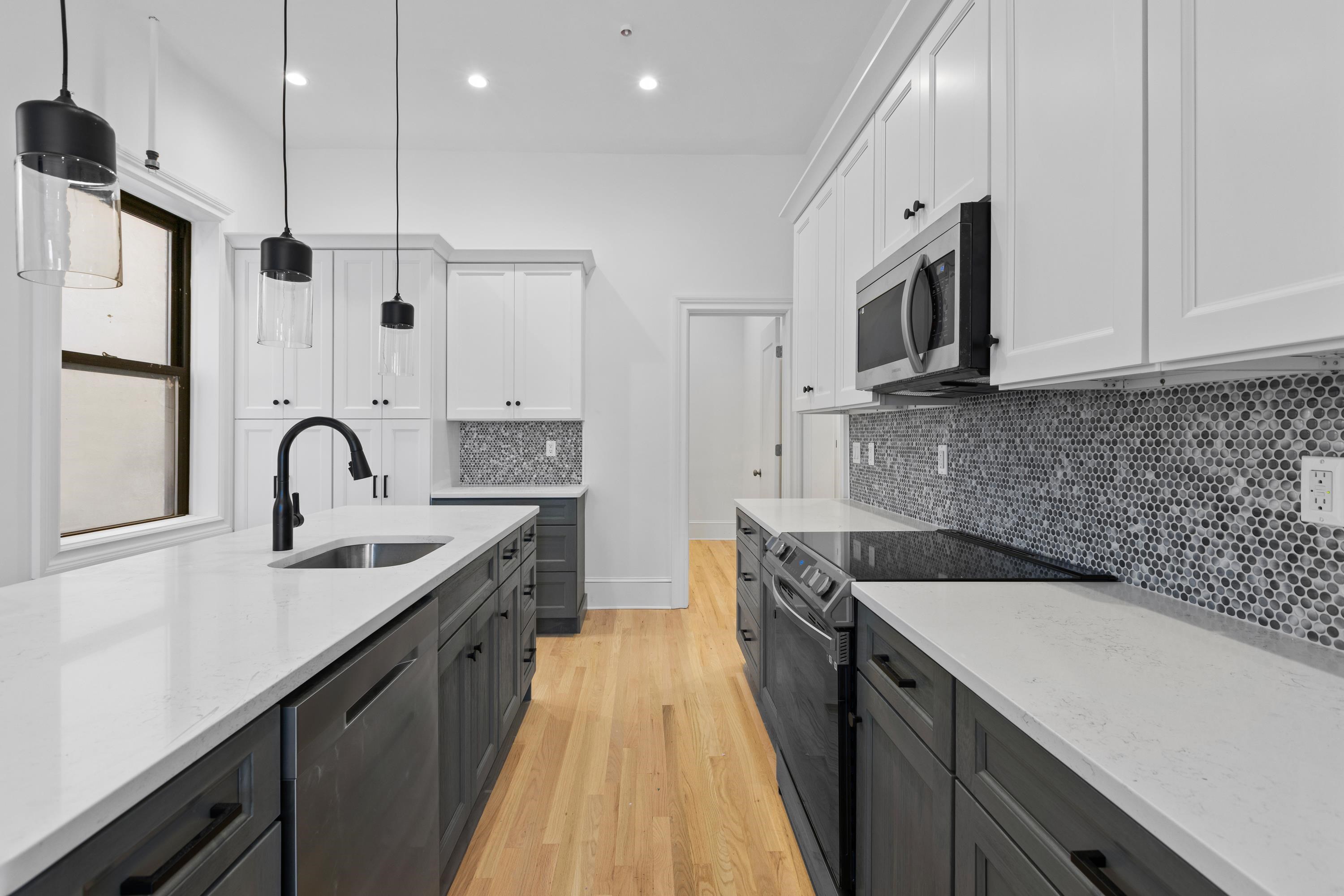 76 Washington Street, Unit 2 Hoboken, NJ 07030 - Photo 4 of 14 a kitchen with stainless steel appliances granite countertop a sink a stove and a wooden floors