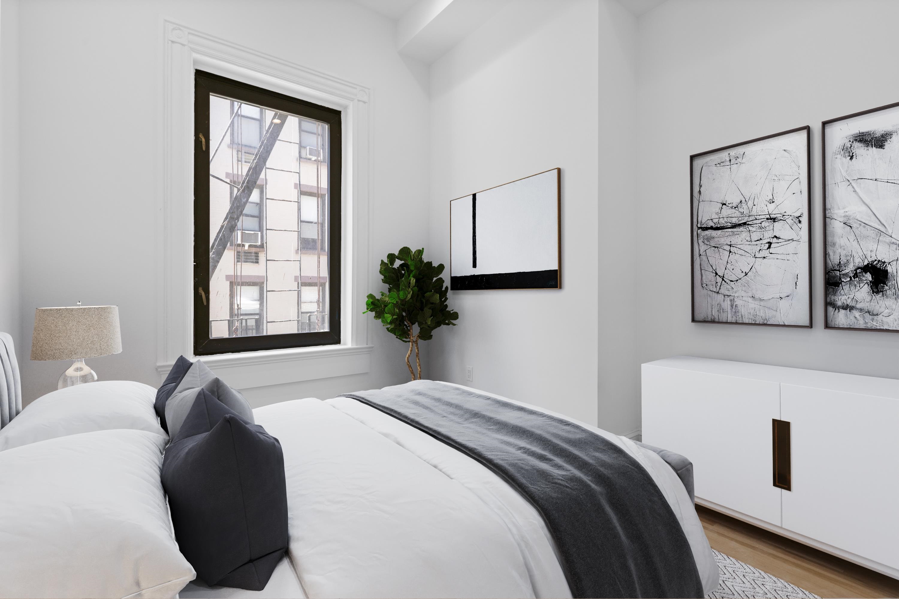 76 Washington Street, Unit 2 Hoboken, NJ 07030 - Photo 8 of 14 a bedroom with a bed and a window