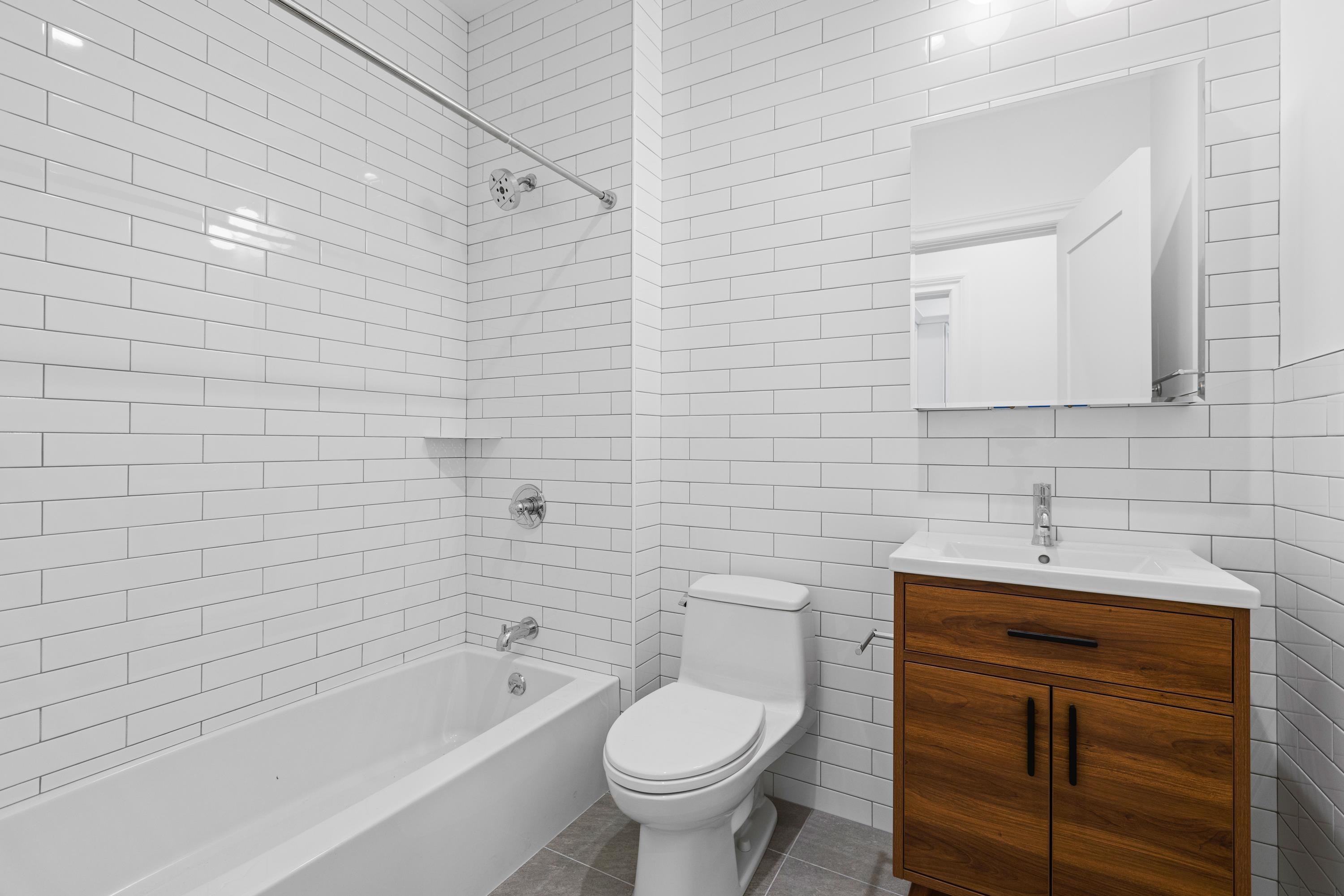 76 Washington Street, Unit 2 Hoboken, NJ 07030 - Photo 10 of 14 a bathroom with a sink a toilet and bathtub
