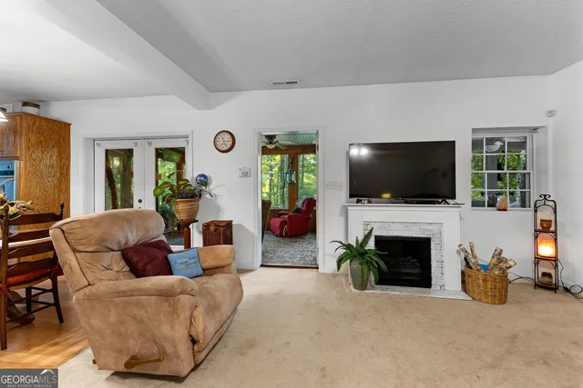 a bedroom with a large bed and a flat tv screen on dresser