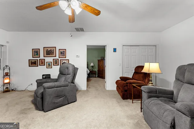 a view of an empty room with a window and a ceiling fan