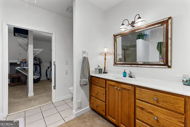 a bedroom with a bed and a ceiling fan