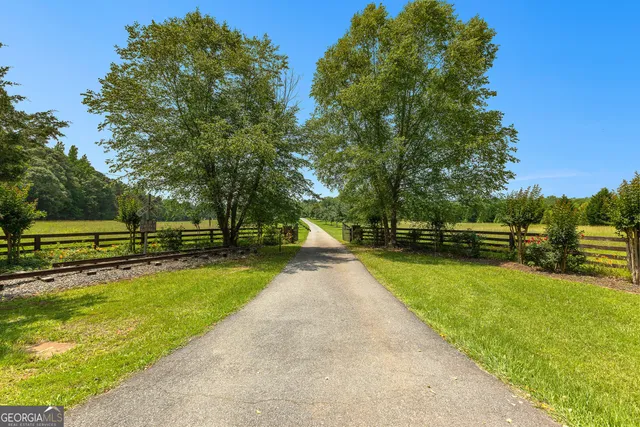 a view of a chairs and fire pit in the backyard