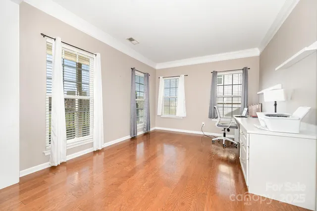 a view of a livingroom with a furniture wooden floor and a window