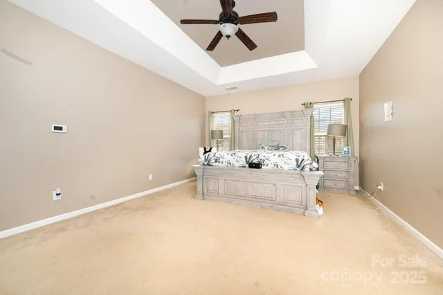 a living room with furniture and ceiling fan