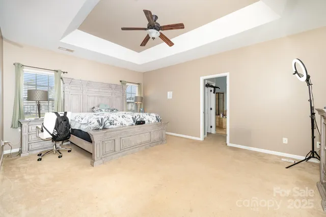a bedroom with furniture and a ceiling fan