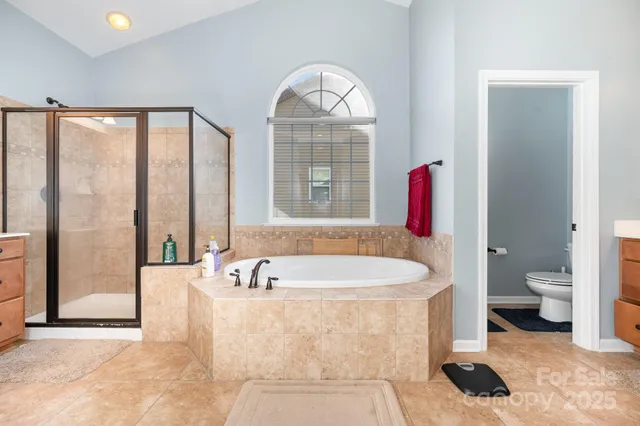 a spacious bathroom with a bathtub and a shower