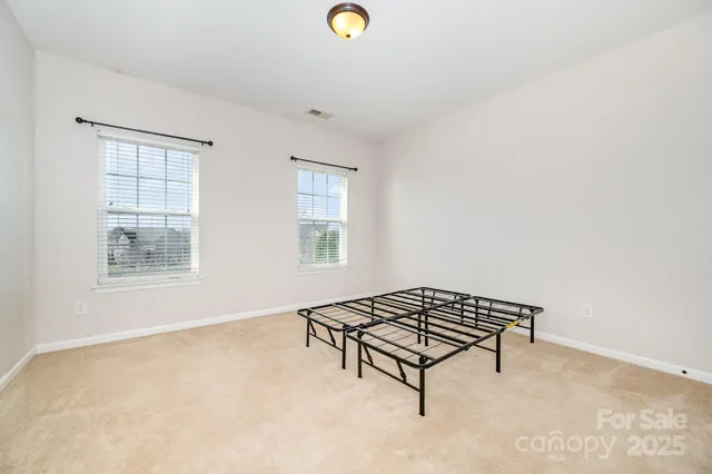 a living room with a baby crib and a window