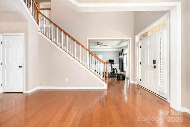 a view of entryway and hall with wooden floor