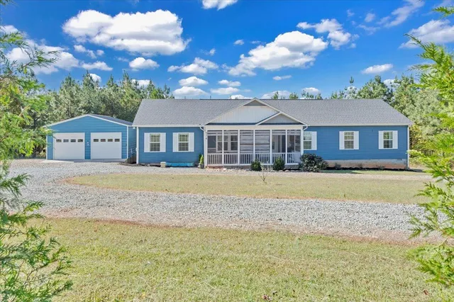 a house with swimming pool in front of it