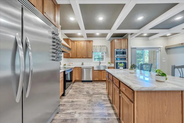 a kitchen with kitchen island a large counter top space appliances and cabinets