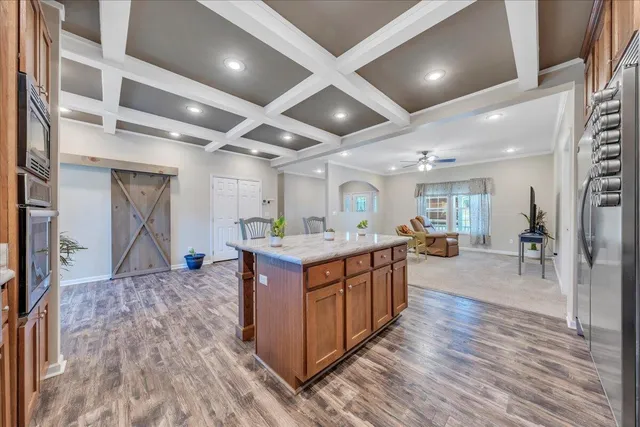 a kitchen with stainless steel appliances granite countertop a sink a stove and a refrigerator