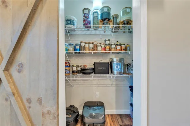 an empty room with furniture and a ceiling fan
