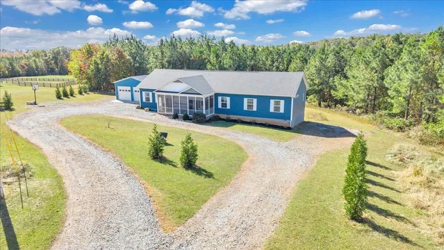 a view of a house with a swimming pool and sitting area