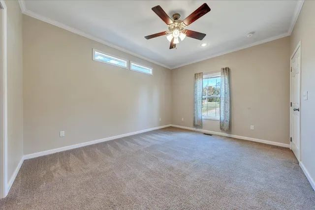 an empty room with closet and windows