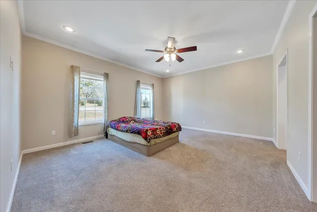 a spacious bathroom with a double vanity sink a mirror and a shower