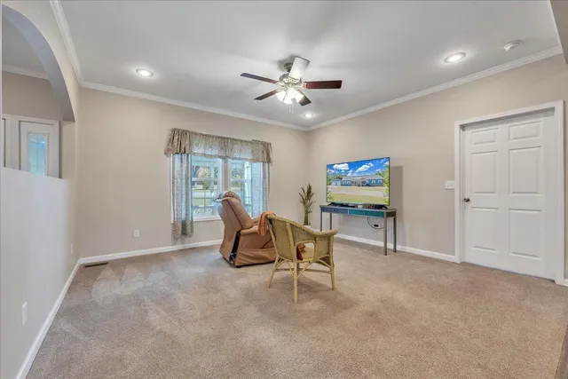 a living room with furniture fireplace and a large window