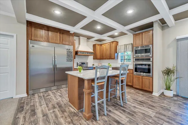 a room with lots of furniture and a kitchen view