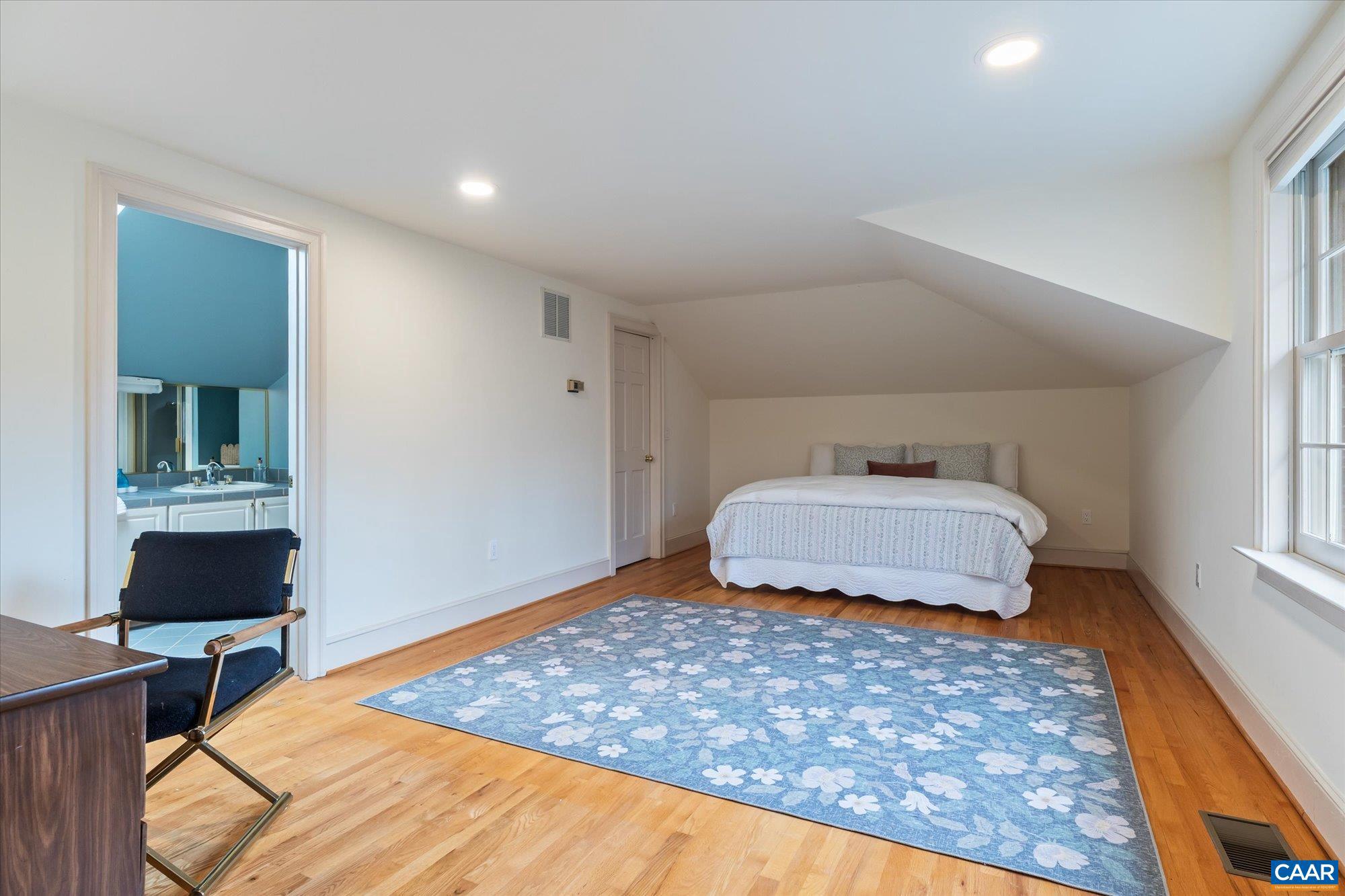1462 Owensville Road Charlottesville, VA 22901 - Photo 34 of 56 a bedroom with a bed and wooden floor