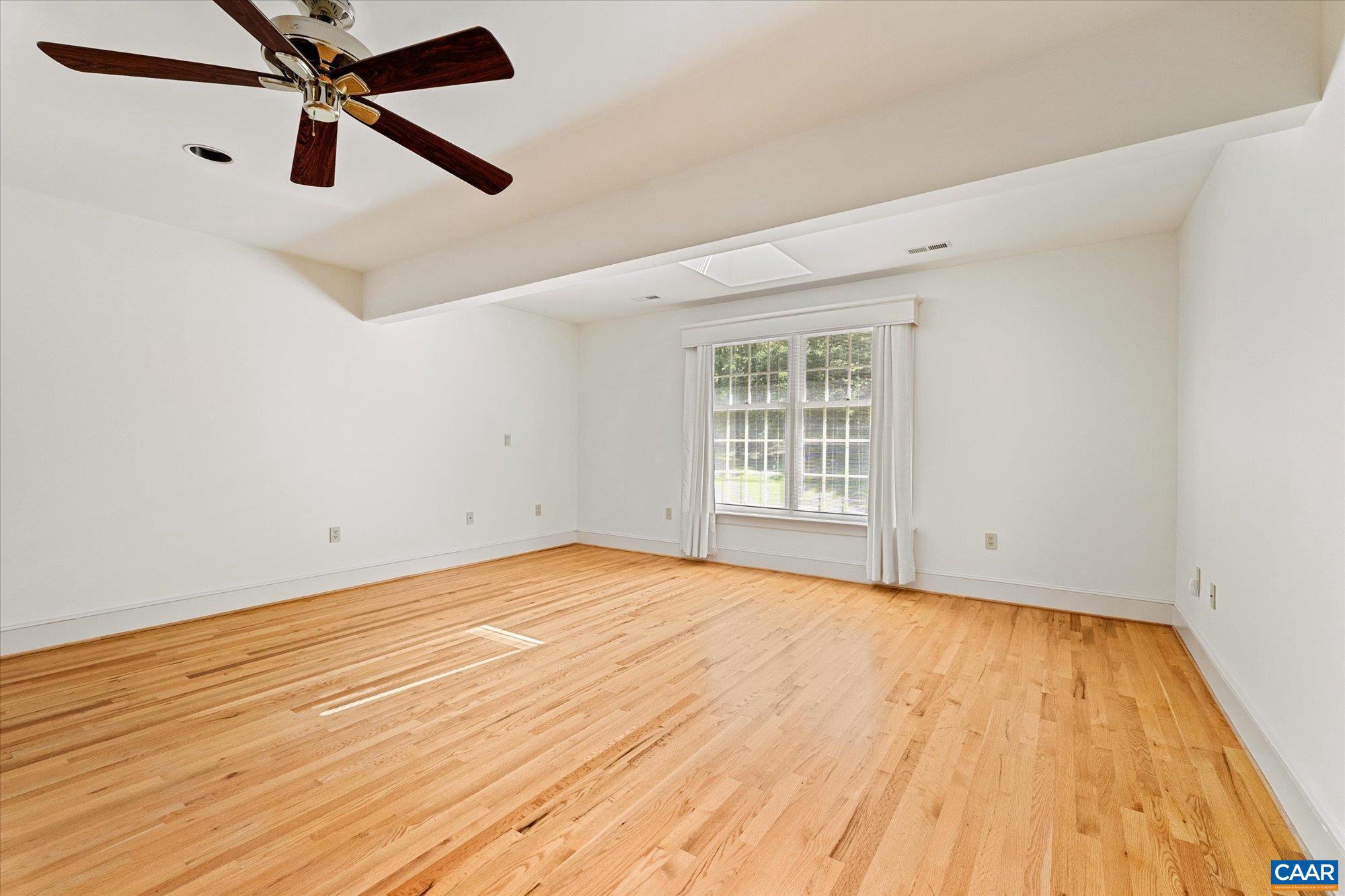 1462 Owensville Road Charlottesville, VA 22901 - Photo 36 of 56 a view of an empty room with wooden floor and a window