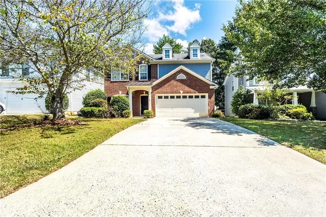 a front view of a house with a yard