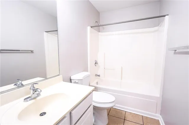 a bathroom with a sink mirror vanity and toilet