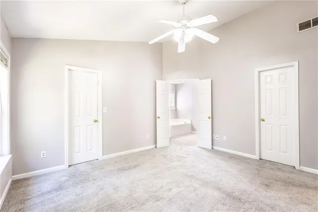 a view of a big room with chandelier fan and closet