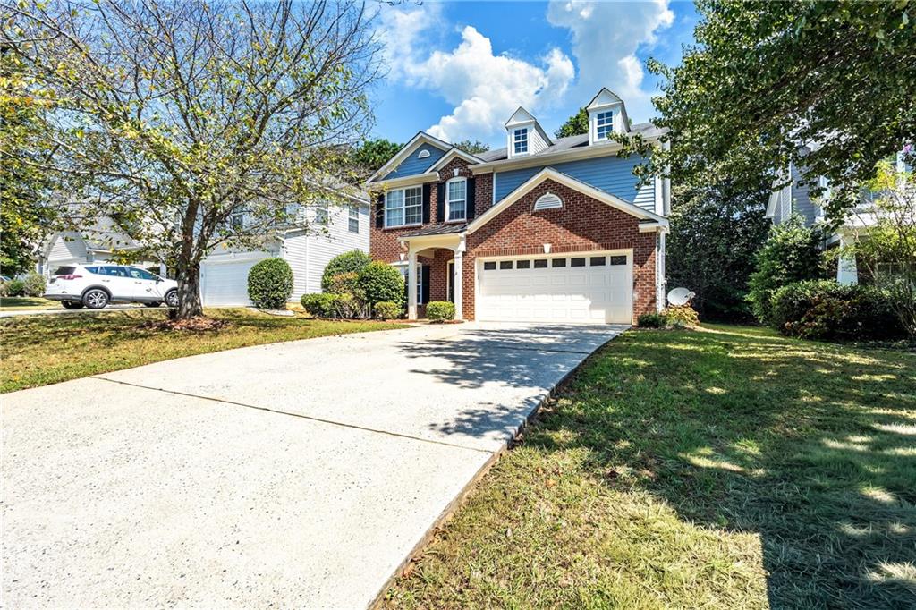 1545 Anna Ruby Lane Kennesaw, GA 30152 - Photo 2 of 45 a front view of a house with a yard