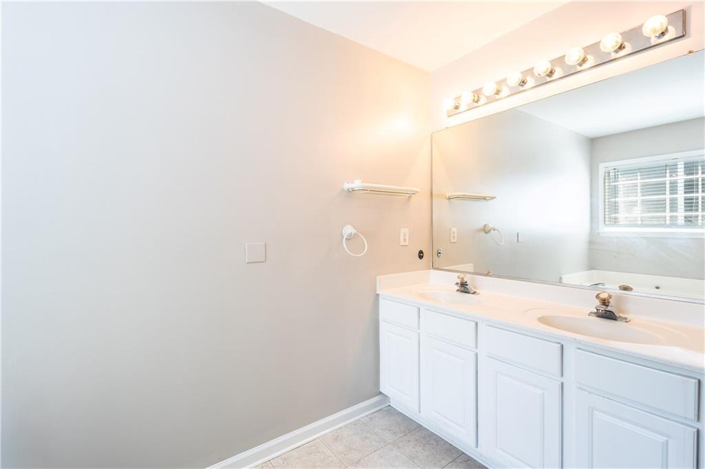 1545 Anna Ruby Lane Kennesaw, GA 30152 - Photo 21 of 45 a bathroom with a sink and a mirror