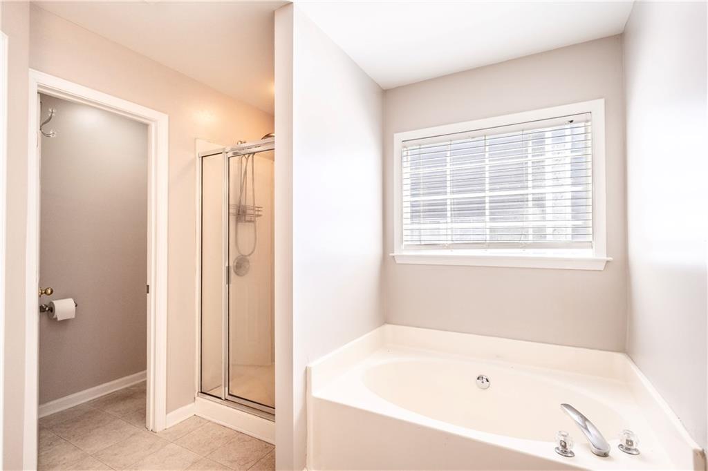 1545 Anna Ruby Lane Kennesaw, GA 30152 - Photo 23 of 45 a white bath tub sitting next to a window