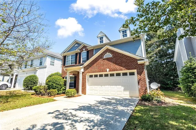a front view of a house with a yard