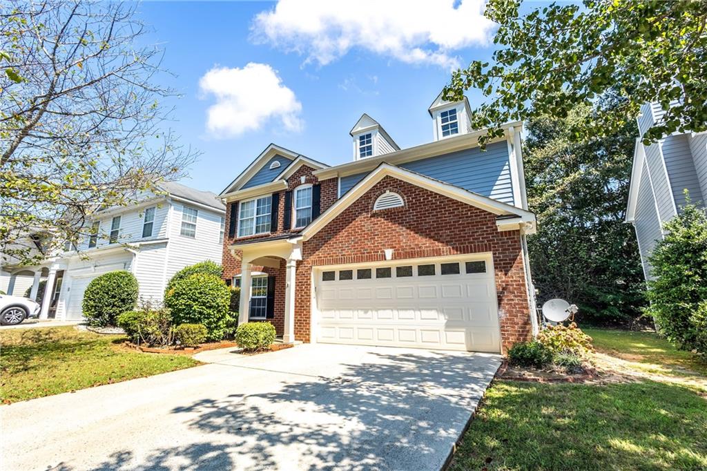 1545 Anna Ruby Lane Kennesaw, GA 30152 - Photo 3 of 45 a front view of a house with a yard