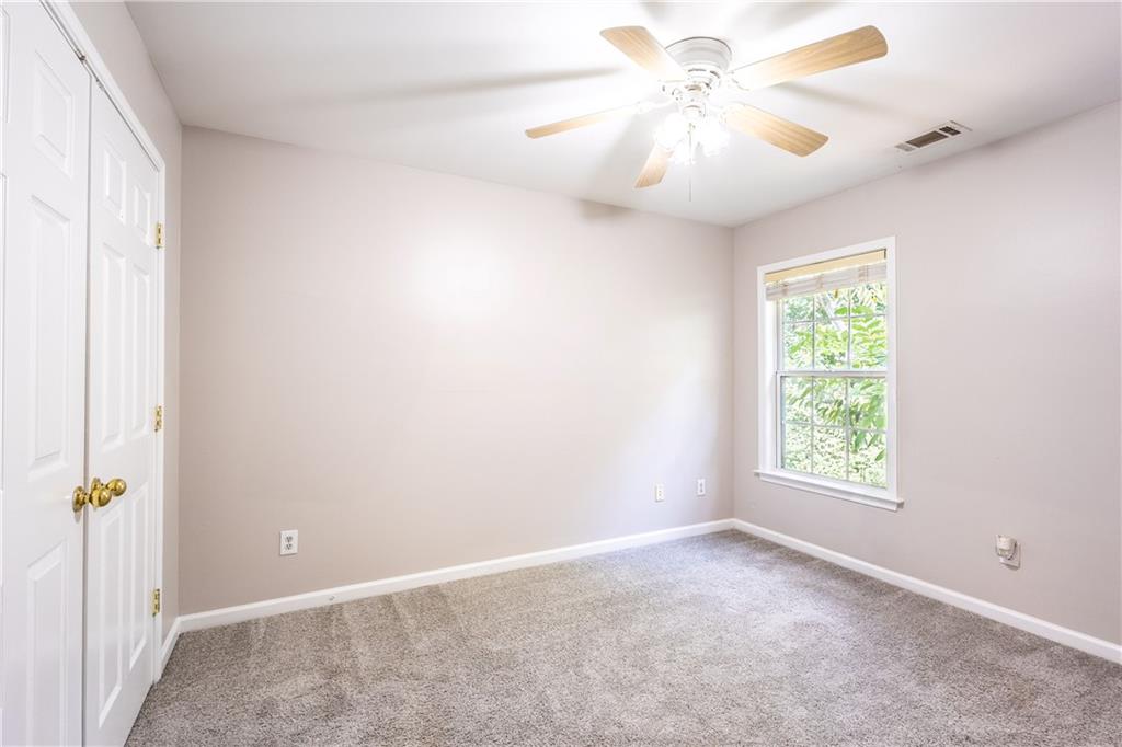 1545 Anna Ruby Lane Kennesaw, GA 30152 - Photo 34 of 45 an empty room with windows and fan
