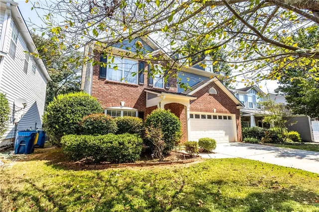 a front view of a house with a yard