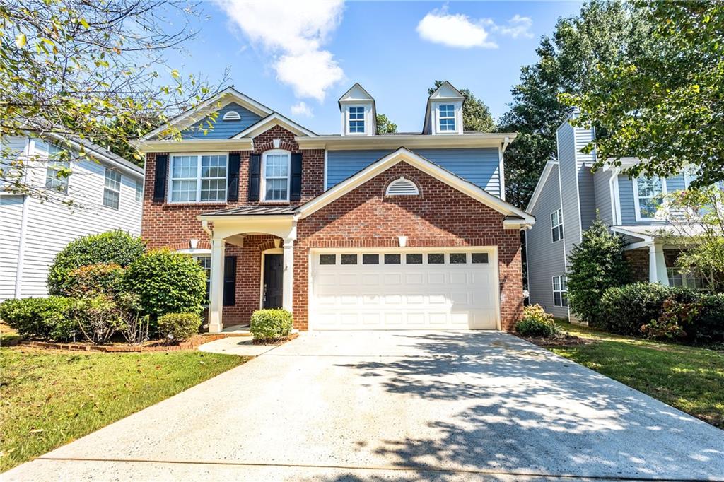 1545 Anna Ruby Lane Kennesaw, GA 30152 - Photo 45 of 45 a front view of a house with a yard and trees