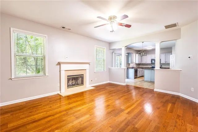 a view of an empty room with a window and fireplace