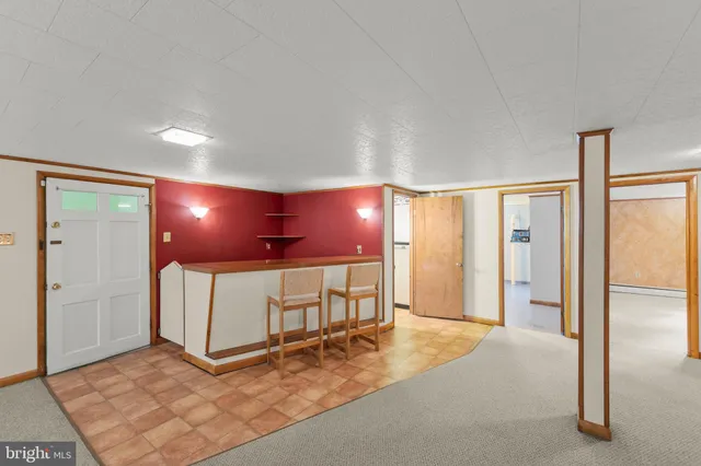 a view of a hallway with workspace and a window