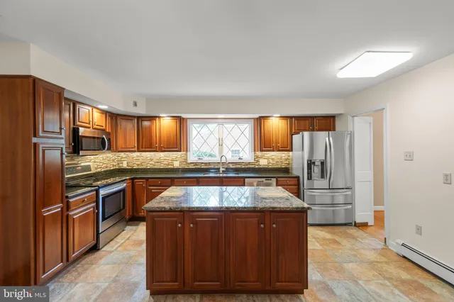 a kitchen with stainless steel appliances granite countertop a stove and a sink