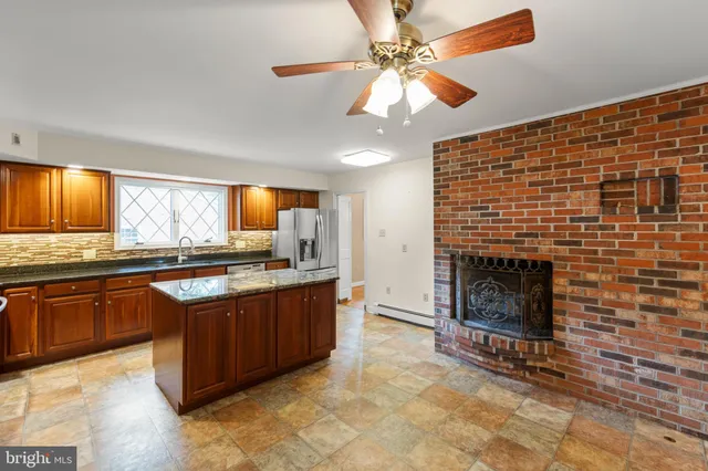 a view of a livingroom with wooden floor and a fireplace