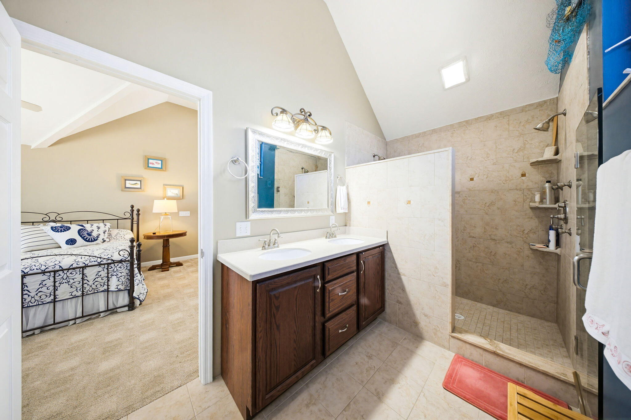 612 Blackbeard Road Summerland Key, FL 33042 - Photo 37 of 68 a spacious bathroom with a double vanity sink a large mirror and shower