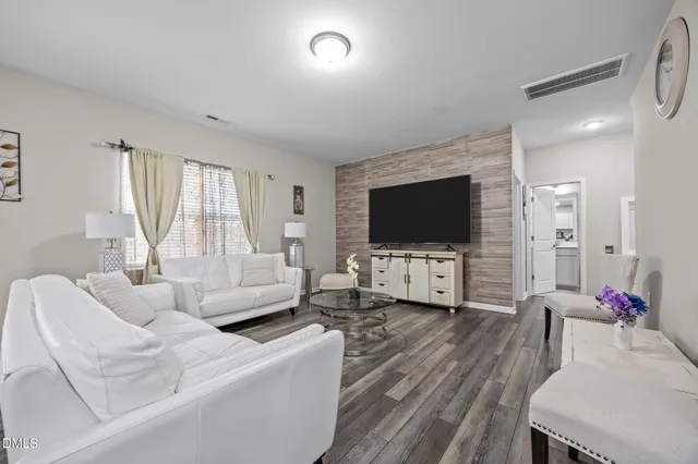 a view of a dining room with furniture and chandelier