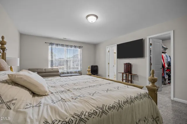 a spacious bedroom with a bed and furniture