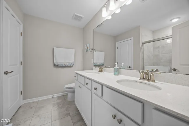 a spacious bedroom with a bed and a cabinets