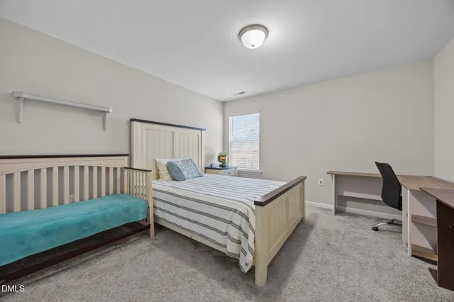 a bedroom with bed and a window