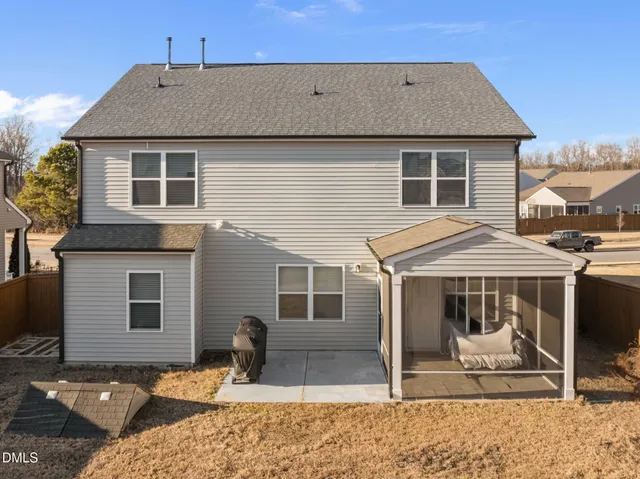 a front view of a house with a balcony and furniture