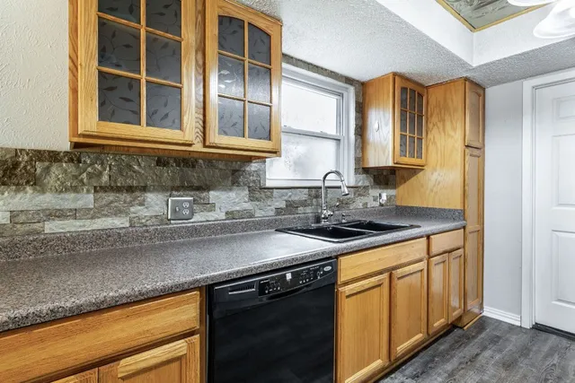 a kitchen with stainless steel appliances granite countertop a sink stove and cabinets