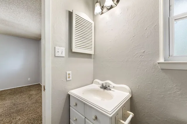 a bathroom with a sink toilet and mirror