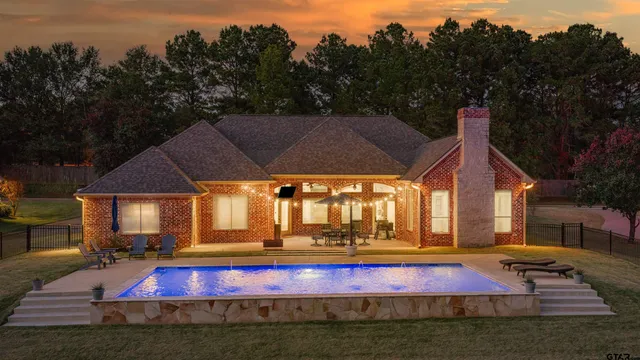 an outdoor space with pool and furniture