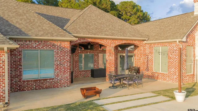 a view of a patio with table and chairs and potted plants